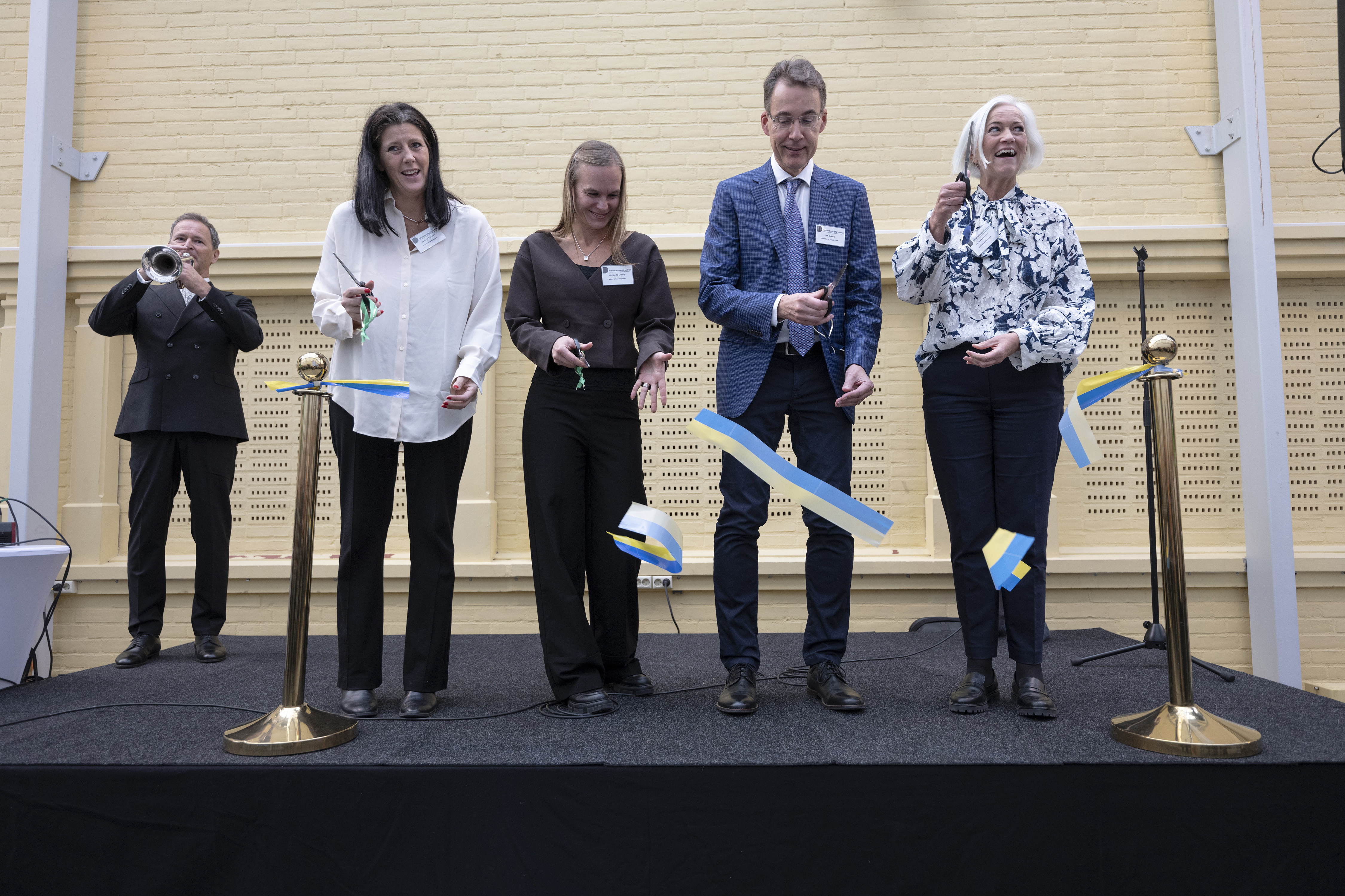 Four people cut the ribbon at the opening of HVC.